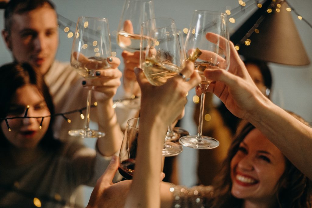Selective Focus Photography of Several People Cheering Wine Glasses happy. Showcasing a woman who has boosted her confidence.