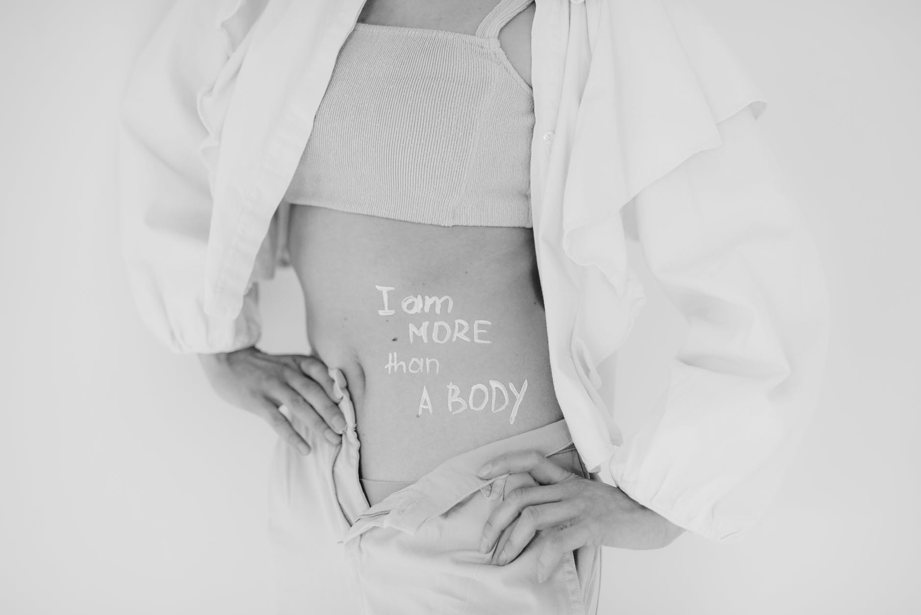 confident young girl with written message on her body about her body image