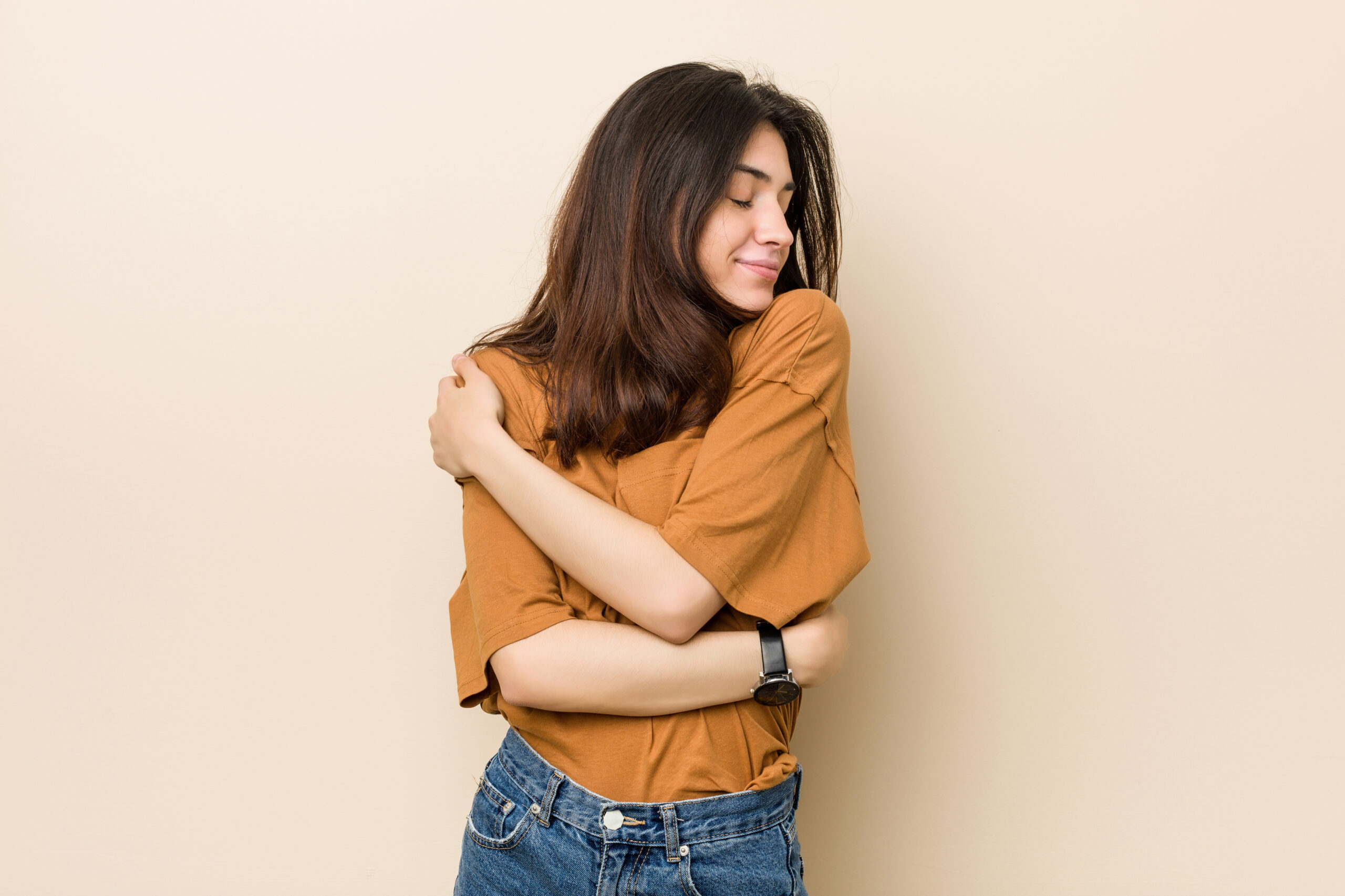 Woman hugging herself practicing self-care