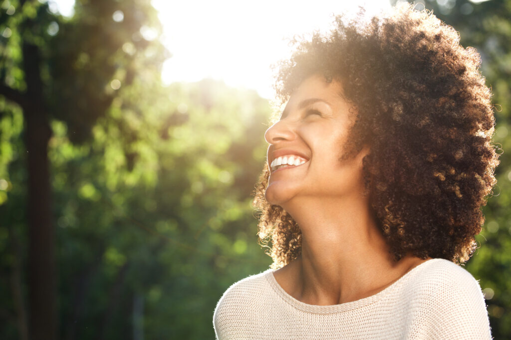 Woman smiling as a result of Practising Self-care 