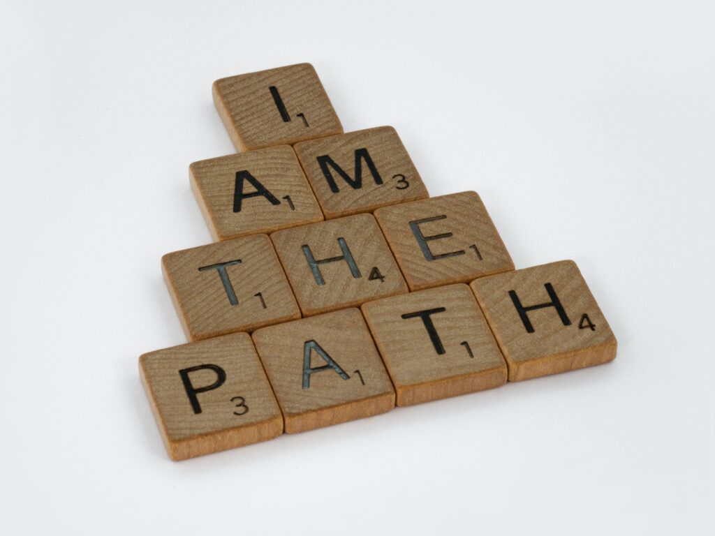 block of wooden scrabble letters spelling out the words "I am the path" to imply that the reader needs to reconnect with themselves to find the way forward. 