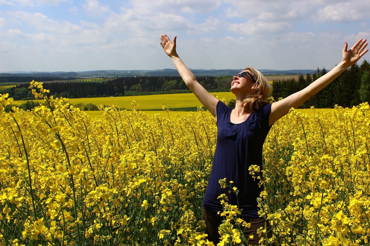 happy woman in field grateful for life
