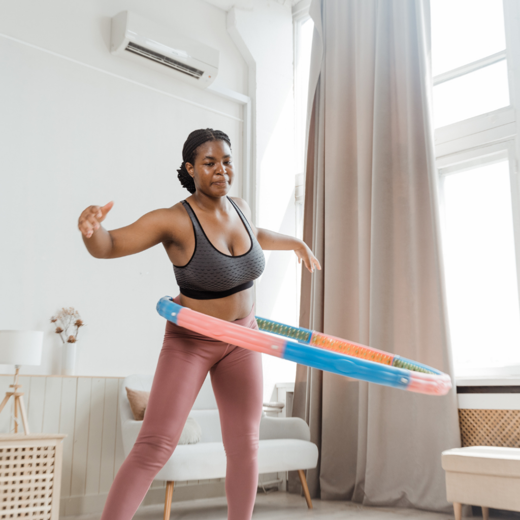 woman using a hula hoop at home